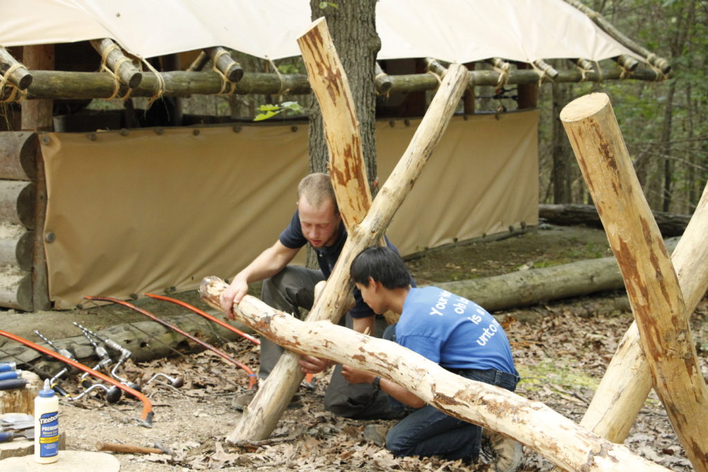 Chief and Camper working with wood